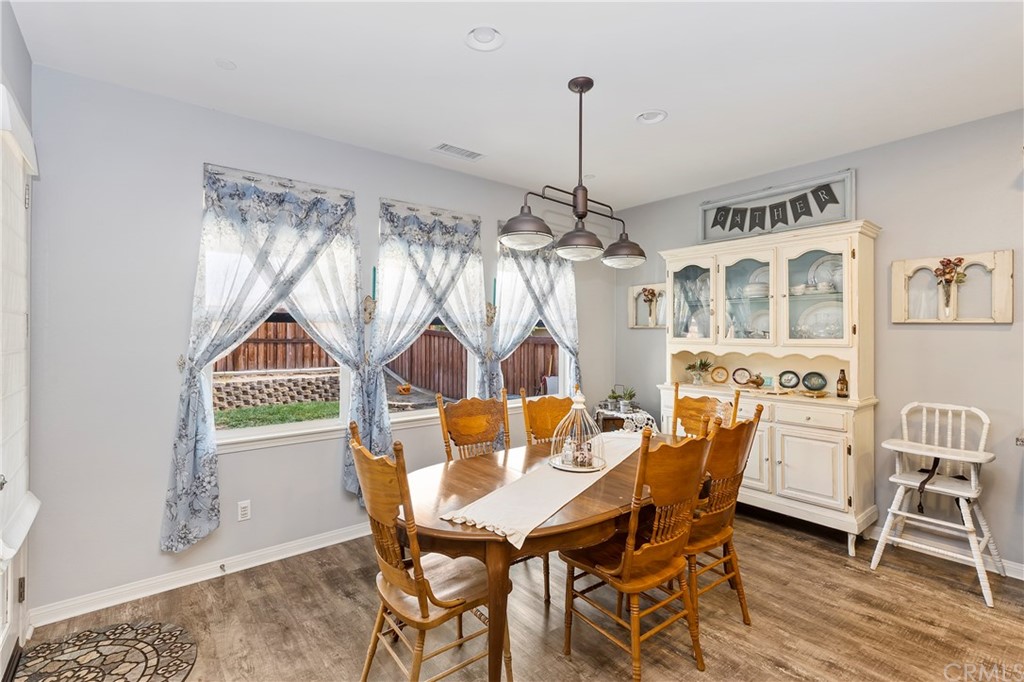 28212 Rustling Wind Circle Menifee, CA 92585 - Photo 8 of 28 a view of a dining room with furniture and chandelier