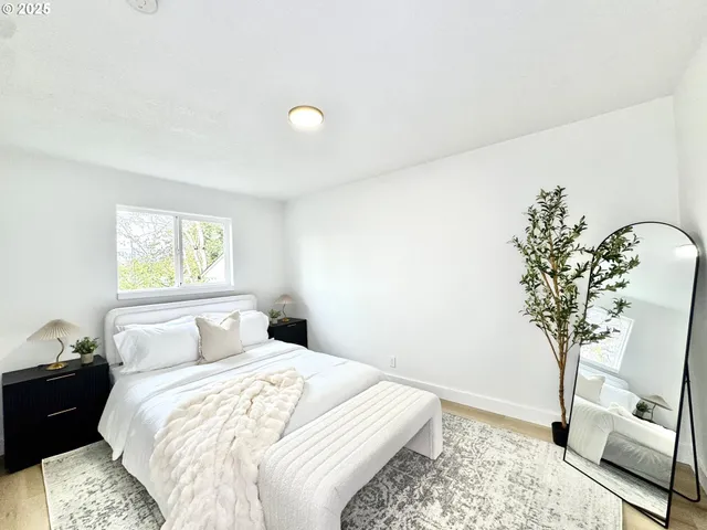 a bedroom with a bed and a potted plant