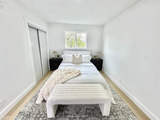 a bedroom with a bed and wooden floor