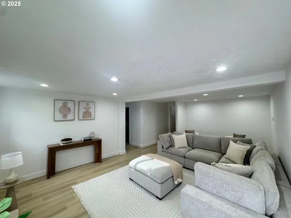 a living room with furniture and a wooden floor