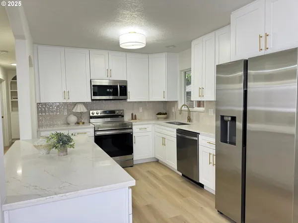 a kitchen with a refrigerator stove and microwave