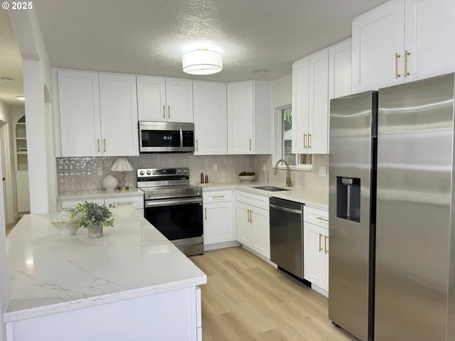 a kitchen with a refrigerator stove and microwave