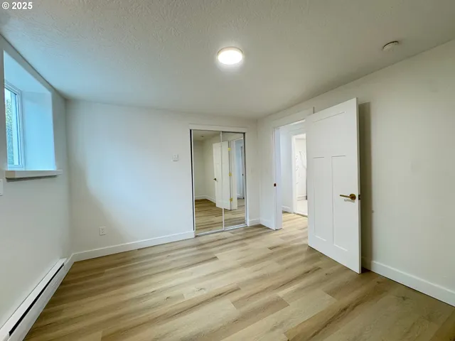 a view of an empty room and wooden floor