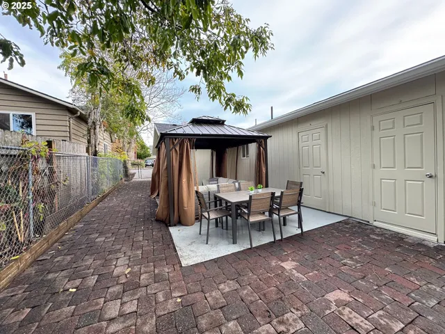 a view of a patio with table and chairs