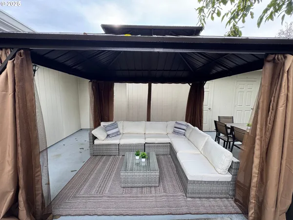 a view of a patio with table and chairs