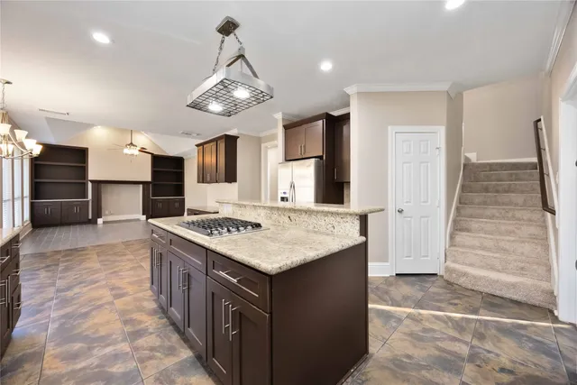 a kitchen with a stove and a kitchen island