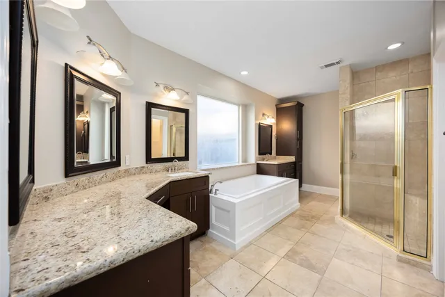 a bathroom with a granite countertop sink mirror and shower