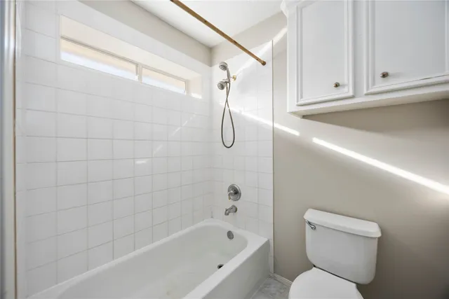 a bathroom with a toilet and a bathtub
