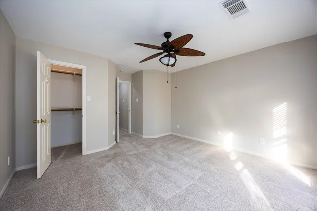 a view of room with a ceiling fan