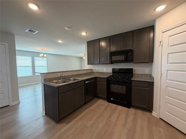 a kitchen with stainless steel appliances granite countertop a stove and a refrigerator