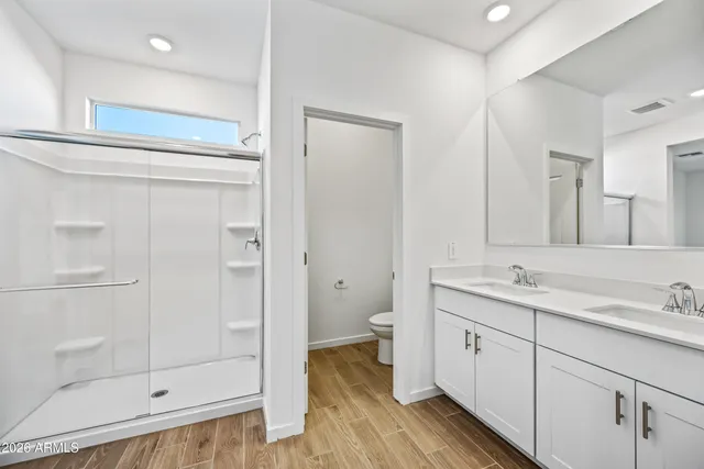 a bathroom with a shower sink and mirror