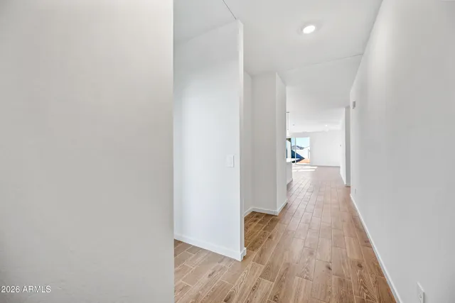 a view of a hallway with wooden floor