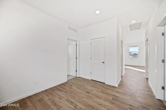 a view of a room with wooden floor and bathroom