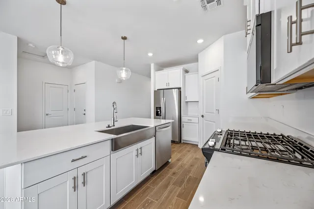 a kitchen with a sink stainless steel appliances and cabinets