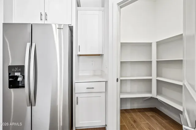 a view of walk in closet with empty racks