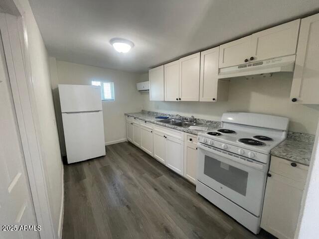 a kitchen with granite countertop white cabinets and white appliances