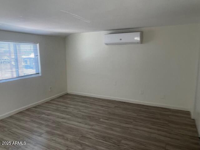 4301 South 7th Avenue, Unit 12 Phoenix, AZ 85041 - Photo 3 of 3 wooden floor in an empty room with a window