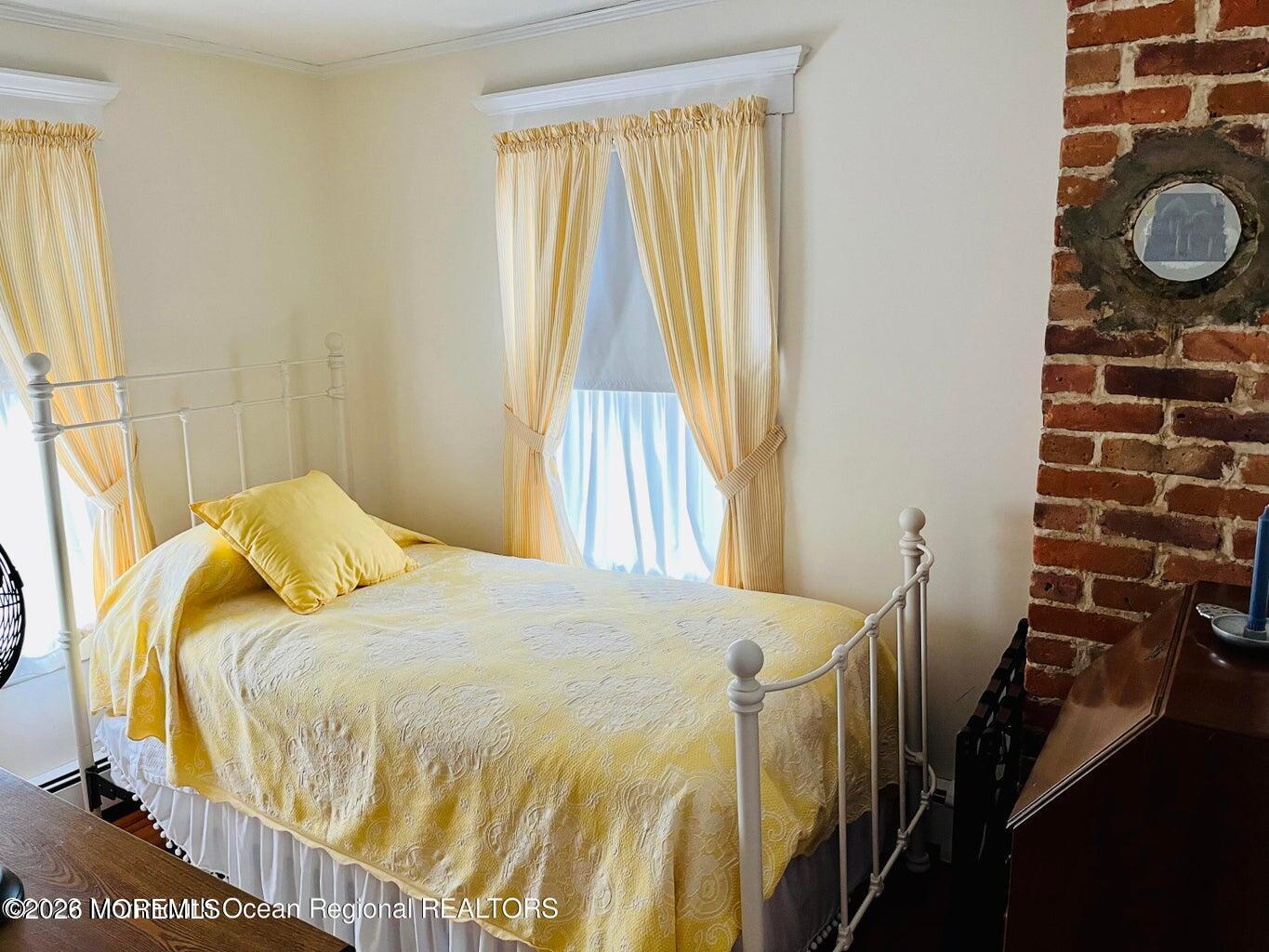 214 Howe Street Point Pleasant, NJ 08742 - Photo 13 of 16 a bedroom with a bed and wooden floor