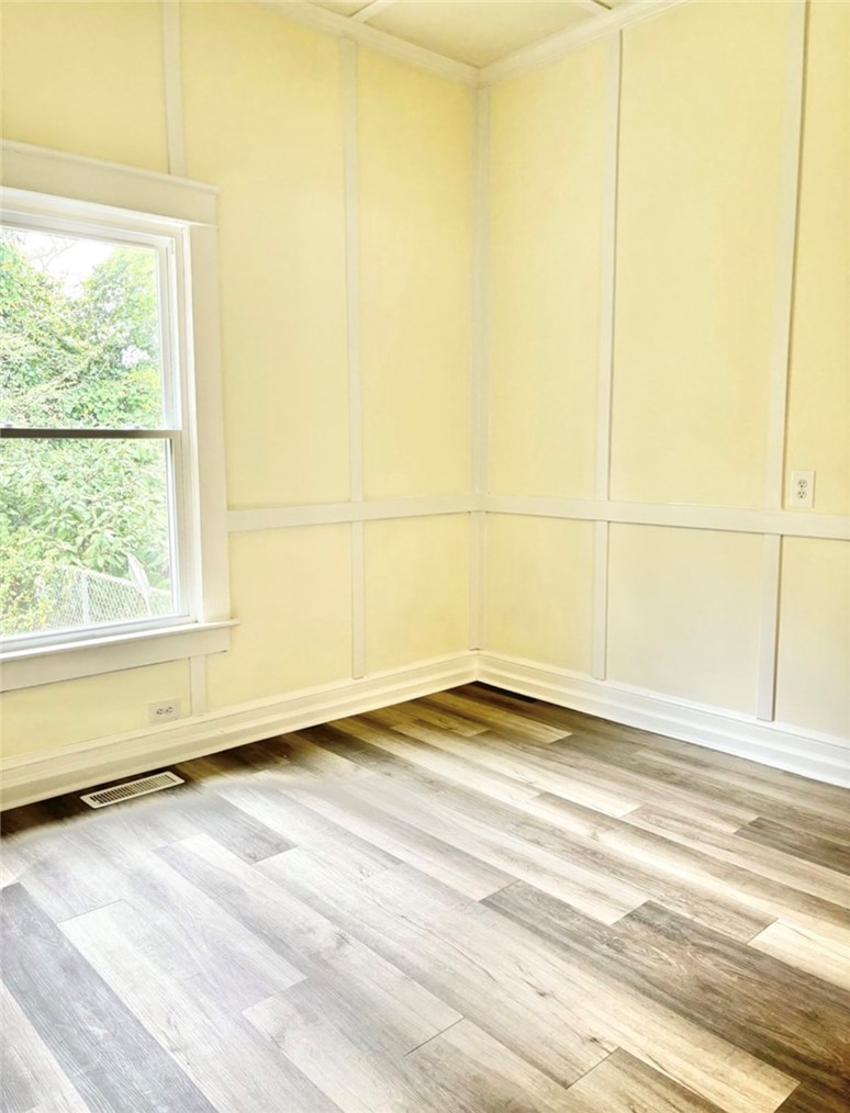 208 Hampton Street Iva, SC 29655 - Photo 14 of 19 This bright room features durable flooring and a window with natural light.