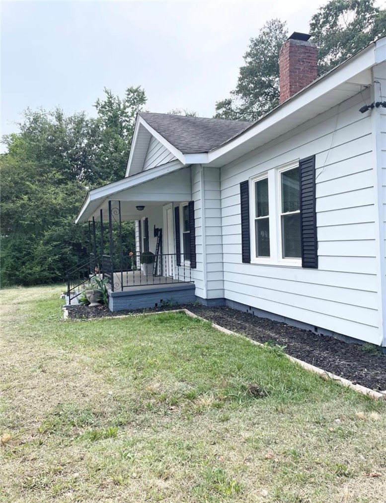 208 Hampton Street Iva, SC 29655 - Photo 2 of 19 This charming home offers a welcoming facade with classic architectural elements and natural surroundings.