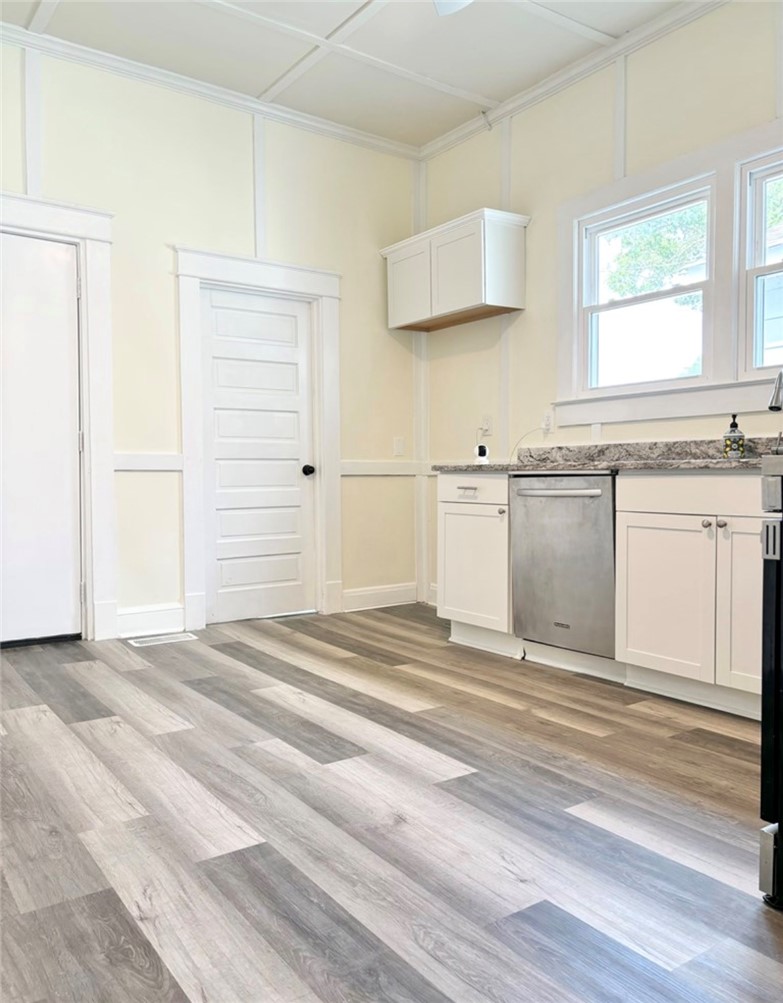 208 Hampton Street Iva, SC 29655 - Photo 5 of 19 This bright kitchen features durable flooring, sleek countertops, and modern appliances.