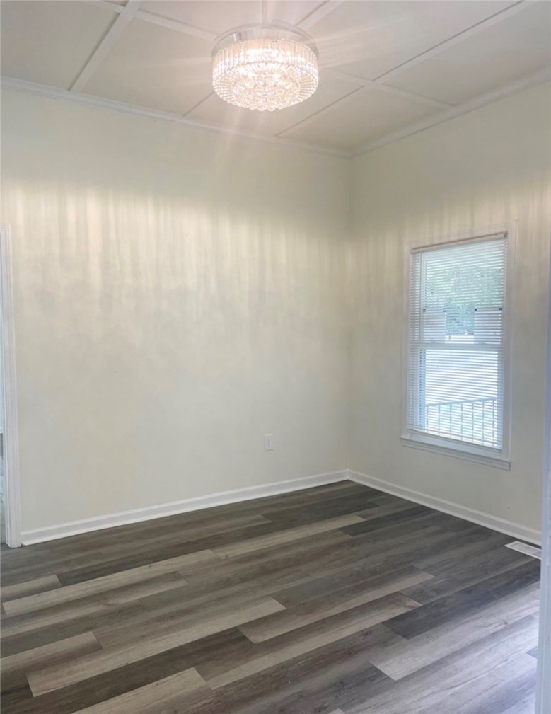 208 Hampton Street Iva, SC 29655 - Photo 9 of 19 This bright space features sleek flooring and a contemporary light fixture, perfect for modern living.