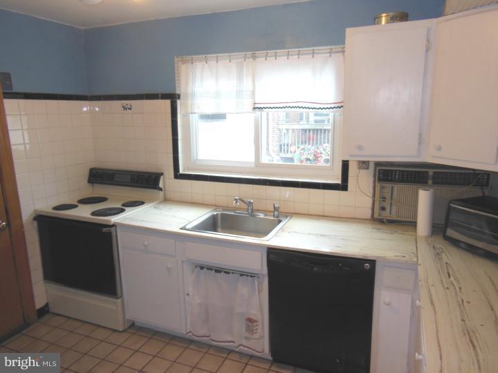 241 Richfield Road Upper Darby, PA 19082 - Photo 13 of 24 a kitchen with a sink stove and cabinets