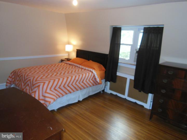 241 Richfield Road Upper Darby, PA 19082 - Photo 21 of 24 a bedroom with a bed and wooden floor