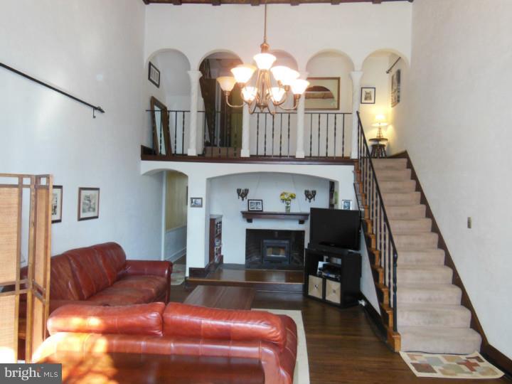 241 Richfield Road Upper Darby, PA 19082 - Photo 7 of 24 a living room with furniture a fireplace and a chandelier