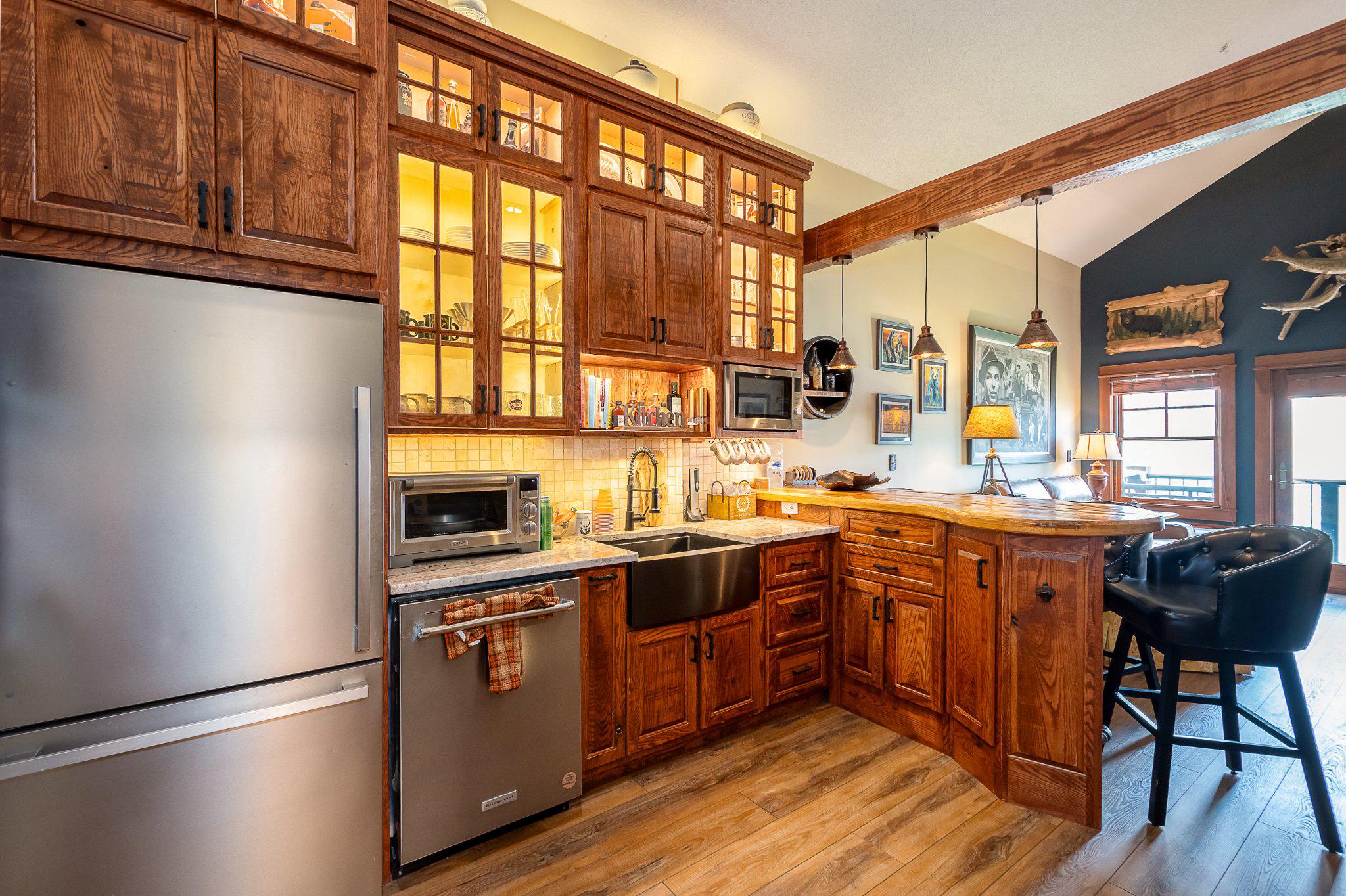 a kitchen with stainless steel appliances granite countertop a stove and a refrigerator
