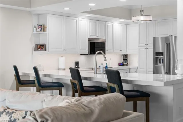 a view of kitchen with cabinets and stainless steel appliances