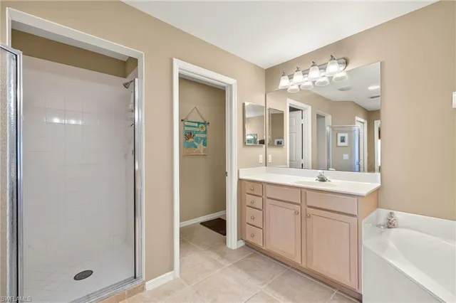 a spacious bathroom with a shower sink and mirror