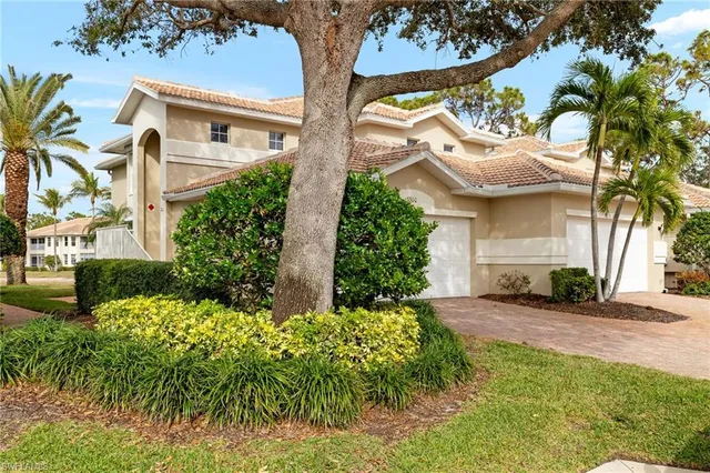 a view of a white house with a yard and plants