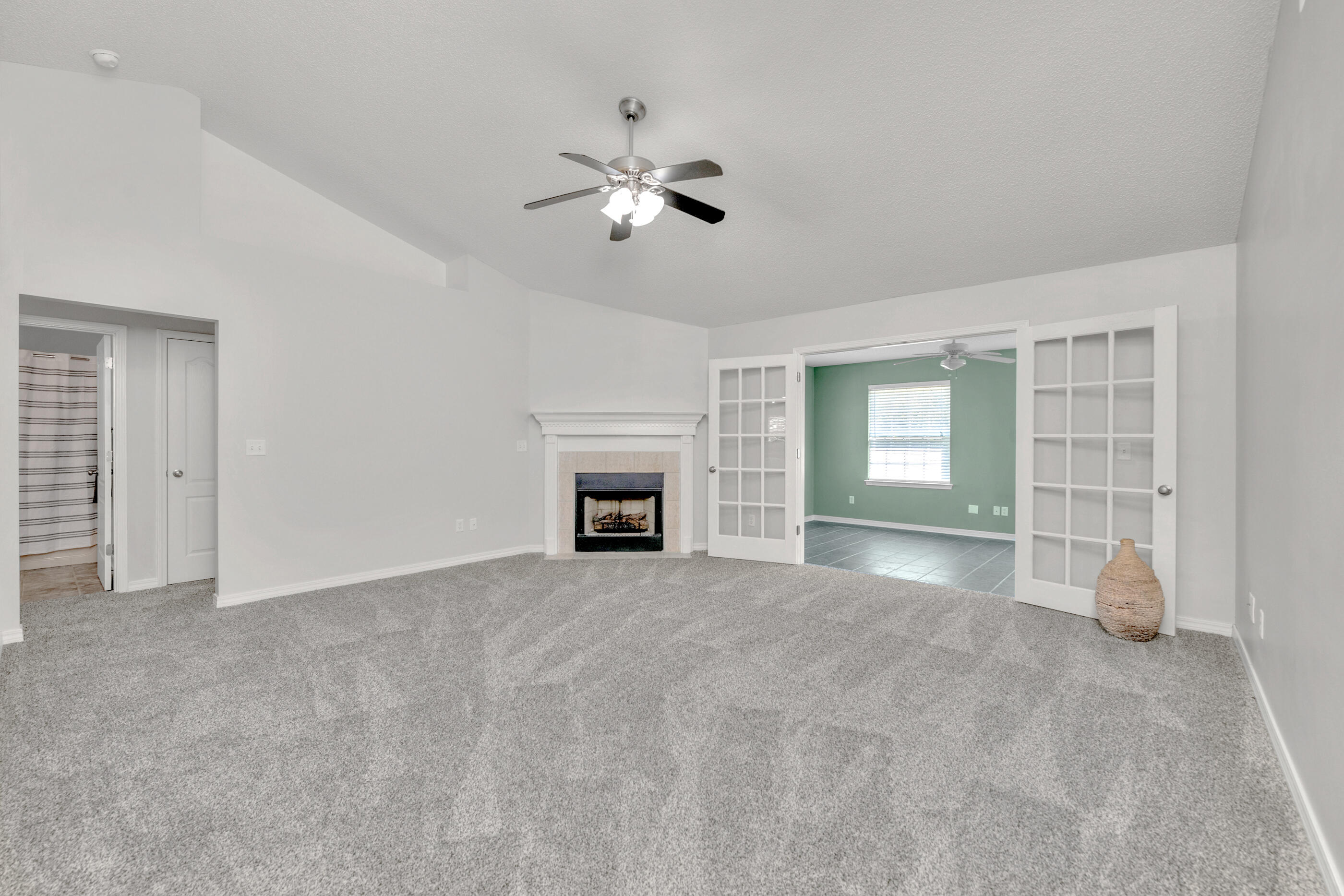 706 Riva Ridge Drive Crestview, FL 32539 - Photo 3 of 22 a view of an empty room with a fireplace and a window