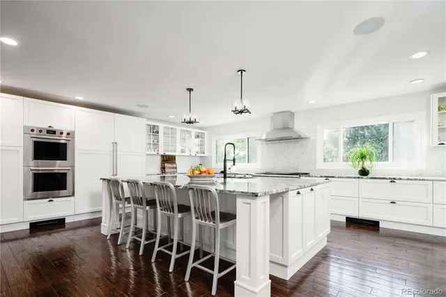 a kitchen with stainless steel appliances a stove and more cabinets