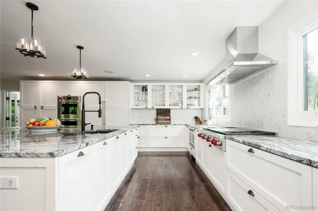 a kitchen with a sink stove and cabinets