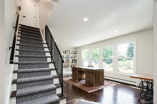 a living room with hard wood floors and a window