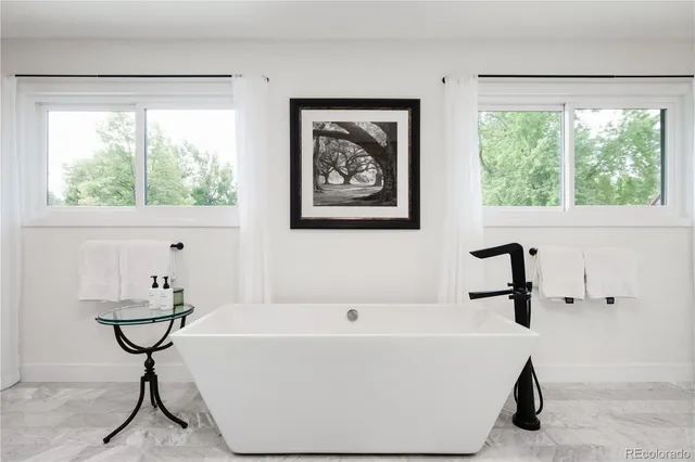 a bathroom with a bathtub and a window
