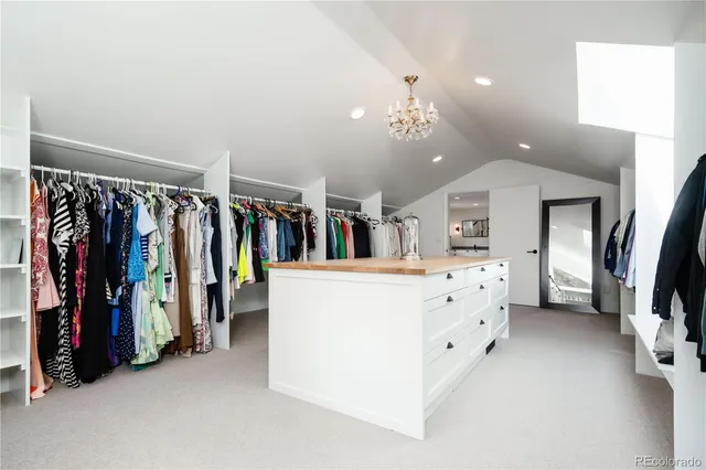 a living room with lots of clothes and storage
