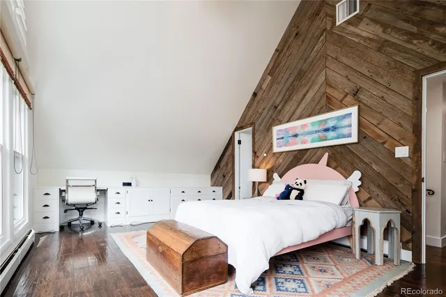 a bed room with a bed and a chair