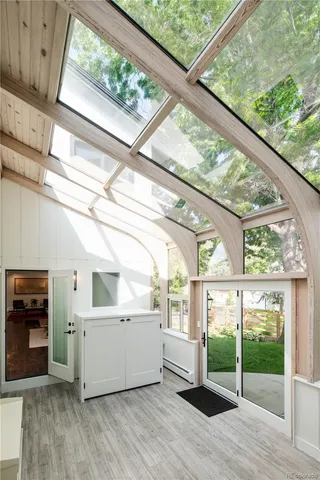 a view of a room with wooden floors and white walls