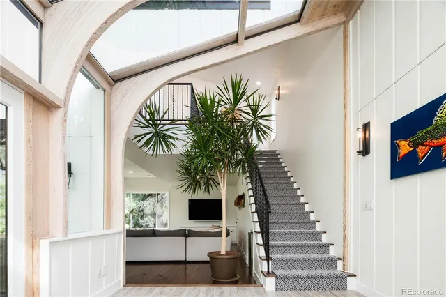 a view of entryway and hall with wooden floor
