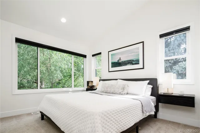 a bedroom with a large bed and a large window