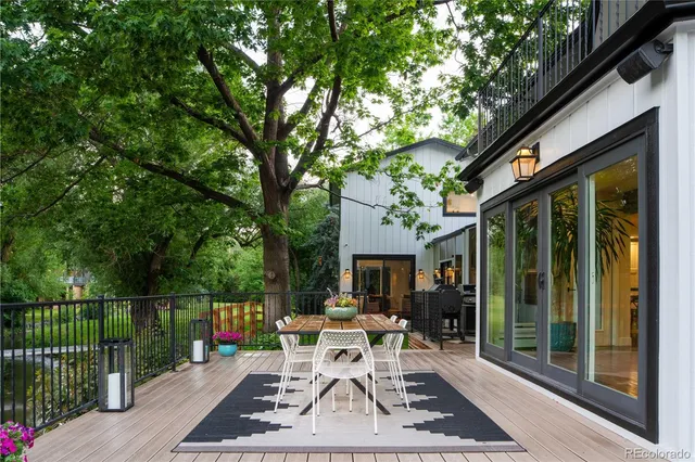 a patio with glass table and chairs