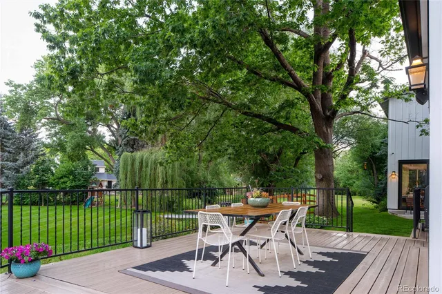 a view of a backyard with a deck and garden