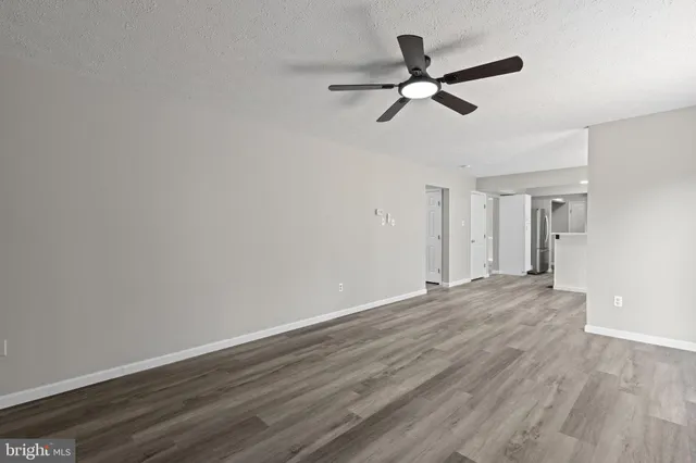 a view of a kitchen with wooden floor and electronic appliances