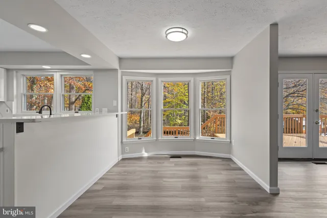 a kitchen with stainless steel appliances granite countertop white cabinets a sink and a stove