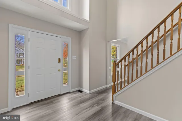 a view of an entryway with wooden floor