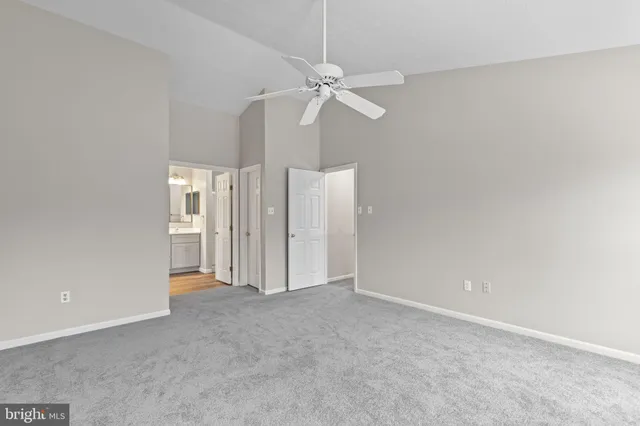 an empty room with windows and closet