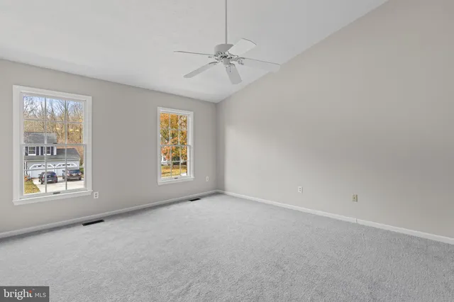 a view of a hallway with a hallway and a livingroom with a white car parked